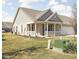 View of a well-maintained brick home with a covered porch and manicured lawn at 1382 Redstone Dr, Avon, IN 46123