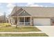 Charming brick home featuring an attached two-car garage and a cozy front porch at 1382 Redstone Dr, Avon, IN 46123
