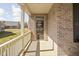 Charming covered porch with a brick facade and view of the neighborhood at 1382 Redstone Dr, Avon, IN 46123