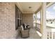 Inviting front porch with comfortable seating and brick accents at 1382 Redstone Dr, Avon, IN 46123