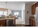 Open-concept kitchen with granite countertops, stainless steel appliances, and hardwood floors flowing into the dining area at 1382 Redstone Dr, Avon, IN 46123