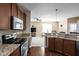 Open kitchen featuring granite counters and stainless steel appliances with a view to the living room at 1382 Redstone Dr, Avon, IN 46123