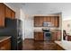 Well-equipped kitchen with stainless steel appliances and dark wood cabinetry at 1382 Redstone Dr, Avon, IN 46123