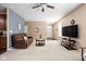Inviting living room with cozy seating, ceiling fan, and a view of the front door at 1382 Redstone Dr, Avon, IN 46123