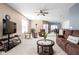 Spacious living room with neutral colors, ceiling fan, and ample natural light at 1382 Redstone Dr, Avon, IN 46123