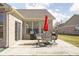 Cozy outdoor patio features a dining set, red umbrella, and grill, perfect for entertaining in style at 1382 Redstone Dr, Avon, IN 46123