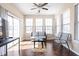 Light-filled sun room with sliding glass doors, a ceiling fan, and wood flooring, perfect for relaxing at 1382 Redstone Dr, Avon, IN 46123