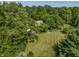 Aerial view of home highlighting the lush lawn, mature trees, and a charming garden, creating a serene outdoor space at 1409 S Harmony Trl, Greenfield, IN 46140