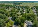 An aerial view of a neighborhood with mature trees, well-maintained lawns, and winding streets at 1409 S Harmony Trl, Greenfield, IN 46140
