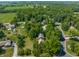 Aerial shot of houses with lush landscaping, highlighting the tree-lined streets and spacious lots in the community at 1409 S Harmony Trl, Greenfield, IN 46140
