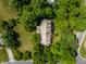 Aerial shot of home and landscaped yard, nestled among mature trees, offering tranquility and privacy in a suburban setting at 1409 S Harmony Trl, Greenfield, IN 46140