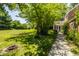 Wide angle view of home and backyard featuring verdant lawn and garden area at 1409 S Harmony Trl, Greenfield, IN 46140