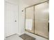This bathroom features a shower with glass doors, white door and neutral colors at 1409 S Harmony Trl, Greenfield, IN 46140