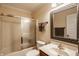 Bathroom with vanity, a bathtub with glass shower doors, and decorative mirror at 1409 S Harmony Trl, Greenfield, IN 46140