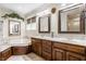 Bright bathroom with double vanity, soaking tub, and elegant mirrors at 1409 S Harmony Trl, Greenfield, IN 46140