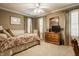 Cozy bedroom with a four-poster bed, dresser, and neutral carpet at 1409 S Harmony Trl, Greenfield, IN 46140