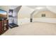 Open bonus room with exercise equipment, neutral paint, and sloped ceilings at 1409 S Harmony Trl, Greenfield, IN 46140