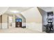 Spacious bonus room with an elliptical machine and a TV on a cabinet at 1409 S Harmony Trl, Greenfield, IN 46140