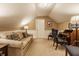Cozy bonus room with neutral colored walls, a couch, and decorative pillows at 1409 S Harmony Trl, Greenfield, IN 46140