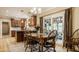 Bright dining area with wood table, chairs, and a view of the outdoor patio at 1409 S Harmony Trl, Greenfield, IN 46140