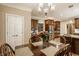 Dining area with wood table, chairs, and a view of the kitchen and workspace at 1409 S Harmony Trl, Greenfield, IN 46140