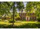 Charming brick home featuring a bright red front door and well-manicured landscaping at 1409 S Harmony Trl, Greenfield, IN 46140