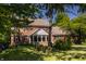 Picture of the exterior of a brick home with well-maintained landscaping and mature trees at 1409 S Harmony Trl, Greenfield, IN 46140