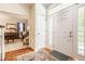 Inviting foyer with wood floors leading to a bright living space with large windows at 1409 S Harmony Trl, Greenfield, IN 46140