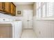 Bright laundry room with washer and dryer hookups and cabinets at 1409 S Harmony Trl, Greenfield, IN 46140