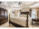 Elegant main bedroom with a tray ceiling, dark wood furniture, and a serene ambiance creates a peaceful sanctuary at 1409 S Harmony Trl, Greenfield, IN 46140