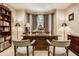 Dedicated home office with custom desk, bay window, and built-in shelving provides a productive and organized workspace at 1409 S Harmony Trl, Greenfield, IN 46140