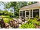 Outdoor patio with a fire pit, surrounded by comfortable seating and lush landscaping at 1409 S Harmony Trl, Greenfield, IN 46140