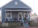 Charming blue bungalow with a cozy front porch and decorative accents at 1507 Hannibal St, Noblesville, IN 46060