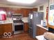 Traditional kitchen featuring stainless steel appliances, wood cabinets, and a window over the sink at 1507 Hannibal St, Noblesville, IN 46060