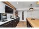 Finished basement bar area with pendant lighting, modern fixtures, shelving, and tile backsplash at 15104 Midland Ln, Noblesville, IN 46062