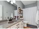 Neutral bathroom featuring a vanity with a vessel sink, updated fixtures, and a shower with a white curtain at 15104 Midland Ln, Noblesville, IN 46062
