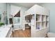 Bright bedroom featuring a loft bed, desk, white ladder, shelving and wood floors at 15104 Midland Ln, Noblesville, IN 46062