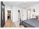 Light-filled bedroom featuring a sliding barn door, ceiling fan, and walk-in closet at 15104 Midland Ln, Noblesville, IN 46062