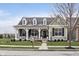 Charming single-Gathering home with a covered porch and swing, complemented by lush landscaping and a welcoming entrance at 15104 Midland Ln, Noblesville, IN 46062