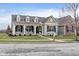 Charming home with a covered front porch and well-manicured lawn at 15104 Midland Ln, Noblesville, IN 46062