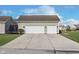 Two-car detached garage with white doors and a large concrete driveway at 15104 Midland Ln, Noblesville, IN 46062