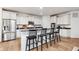 Well-equipped kitchen with stainless steel appliances, white cabinets, granite countertops, and a convenient breakfast bar at 15104 Midland Ln, Noblesville, IN 46062