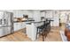 Modern kitchen with white cabinets, granite countertops, stainless steel appliances, and a breakfast bar with seating at 15104 Midland Ln, Noblesville, IN 46062