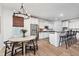 Contemporary kitchen with stainless steel appliances, white cabinetry, a breakfast bar, and an adjacent dining area at 15104 Midland Ln, Noblesville, IN 46062