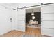 Bright office with modern barn doors, desk, decor, and a cozy rug, creating a stylish workspace at 15104 Midland Ln, Noblesville, IN 46062