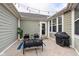 Private backyard patio with cozy seating area, outdoor lighting, and a grill, perfect for entertaining at 15104 Midland Ln, Noblesville, IN 46062