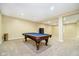 Spacious finished basement featuring a pool table with blue felt and neutral carpeting at 15506 Slateford Rd, Noblesville, IN 46062