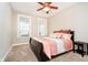 Comfortable bedroom with a ceiling fan, plush carpeting, and large windows for natural light at 15506 Slateford Rd, Noblesville, IN 46062