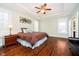 Comfortable bedroom with hardwood floors, natural light, tray ceiling, and ample space at 15506 Slateford Rd, Noblesville, IN 46062