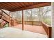 This image showcases a large, covered deck with stairs, providing an outdoor living space with views of the surrounding trees at 15506 Slateford Rd, Noblesville, IN 46062